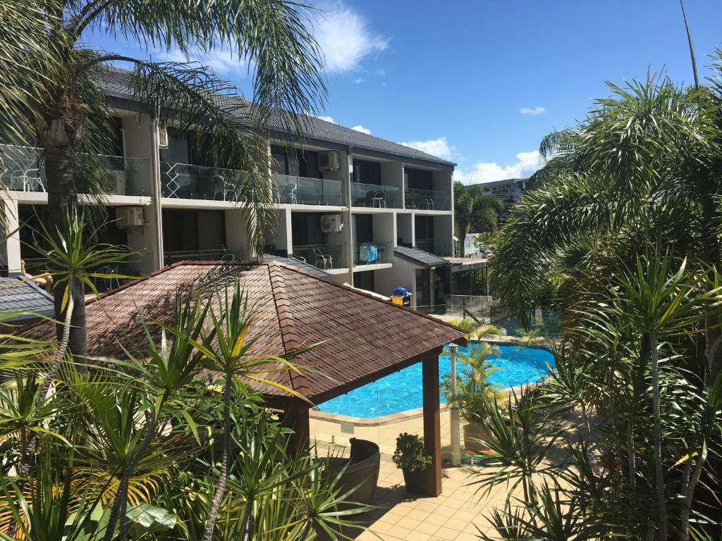 a resort with a swimming pool and a building at Burleigh Palms Holiday Apartments in Gold Coast