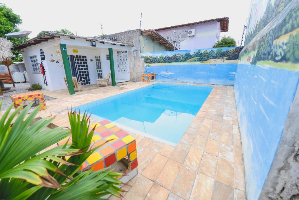 a swimming pool in a yard with a house at Hotel Hostel Caçari in Boa Vista