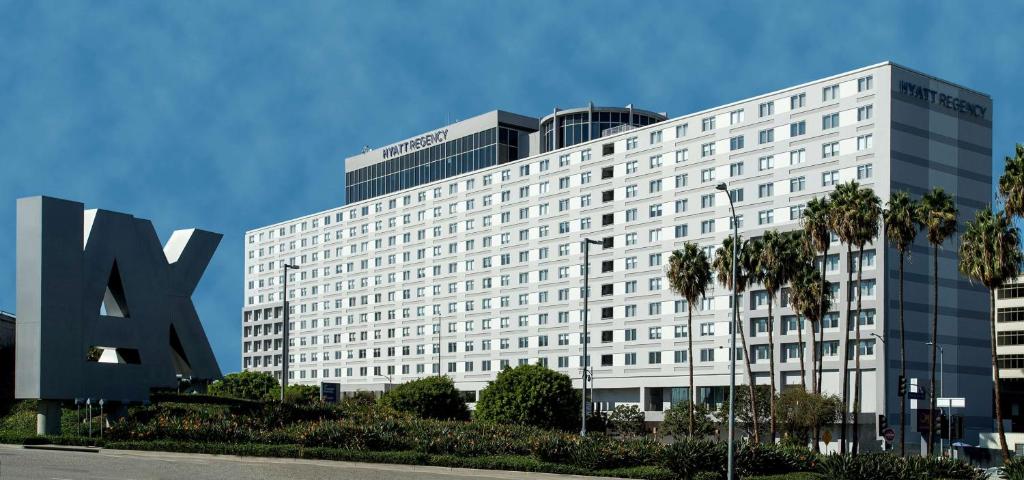 a large white building with a sign in front of it at Hyatt Regency Los Angeles International Airport in Los Angeles