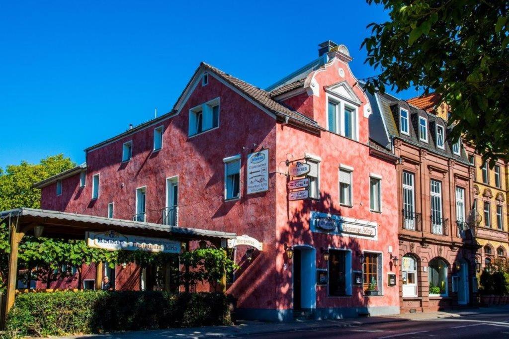 a red building on the side of a street at Villa Croatia & Restaurant Adria in Klingenberg am Main