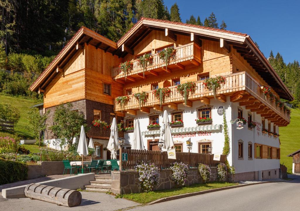 a large building with umbrellas in front of it at Landgasthof Adler in Hinterhornbach