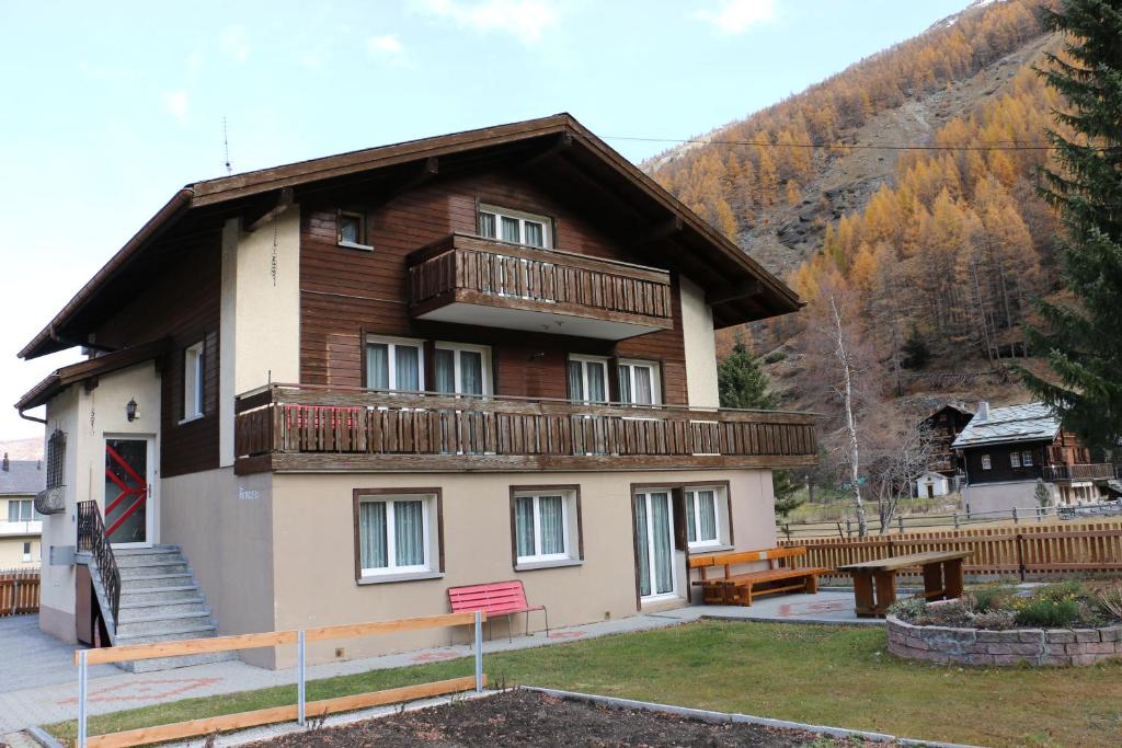 a house with a balcony on the side of it at Haus Amara in Saas-Grund