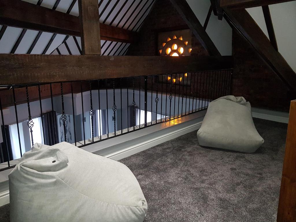 a living room with a chair and a fireplace at The Glebe Hotel in Liverpool