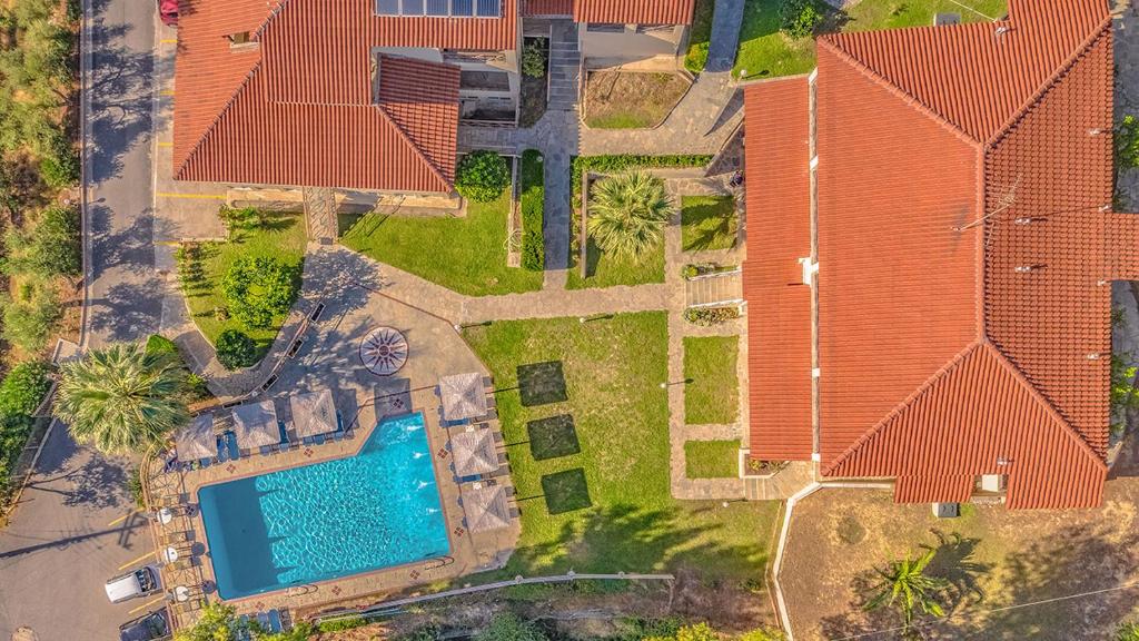an overhead view of a house with a swimming pool at Thea Hotel in Possidi