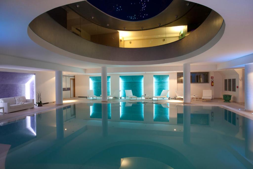 a large swimming pool with a circular ceiling at Arthotel & Park Lecce in Lecce