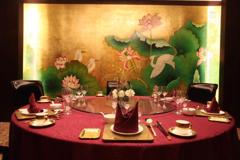 
a table topped with plates filled with food at Geosciences International Conference Centre Hotel in Beijing
