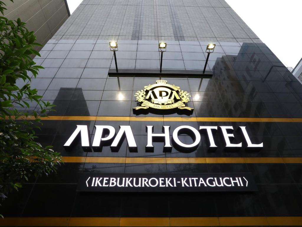 a sign on the side of a apa hotel building at APA Hotel Ikebukuro Eki Kitaguchi in Tokyo