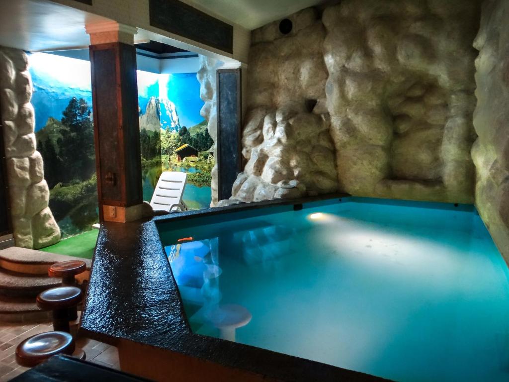 a large swimming pool in a room with a window at El Gran Marques Hotel/Motel in Río Blanco