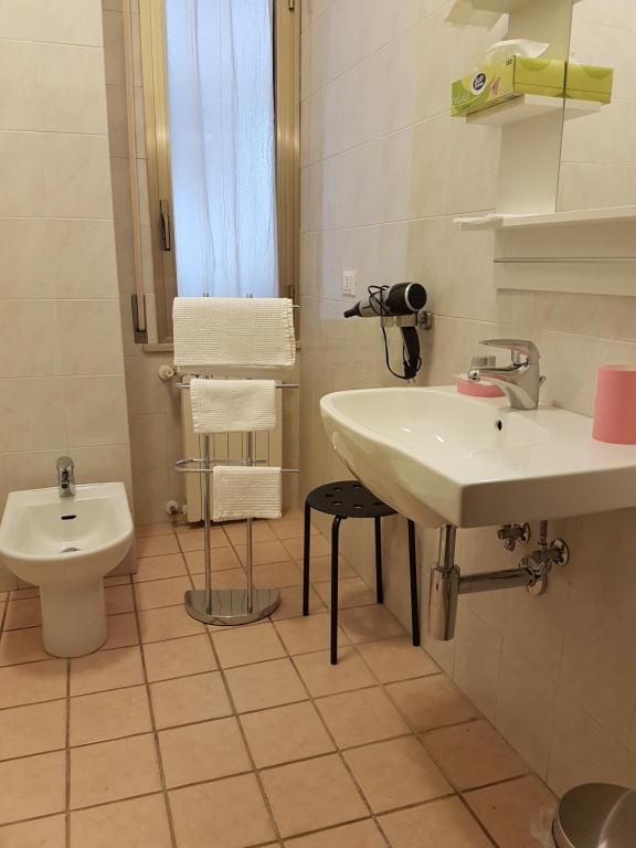 a white bathroom with a sink and a toilet at B&B Monté in Montesilvano