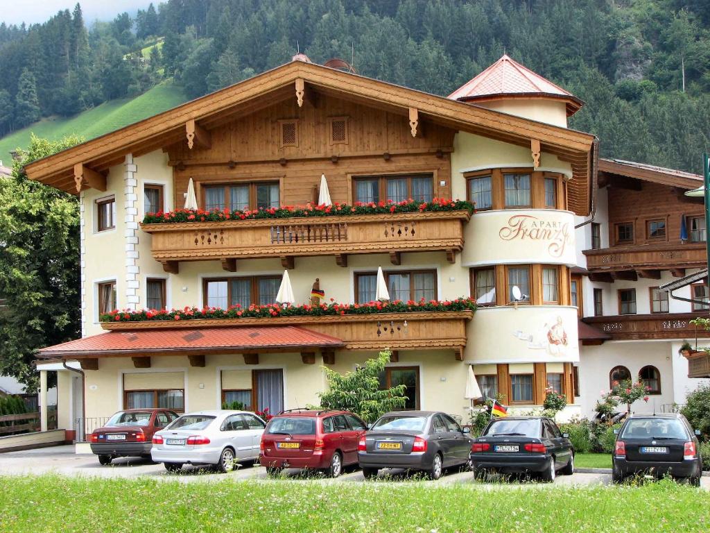 a large building with cars parked in front of it at Apart Franz Josef in Stumm