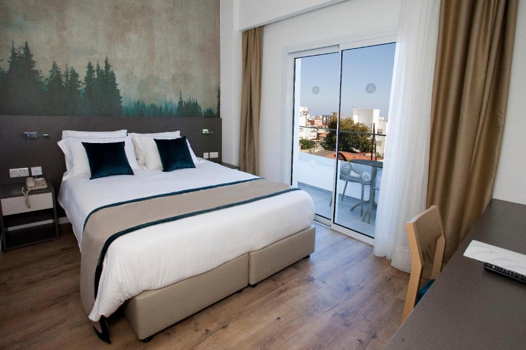 Postel nebo postele na pokoji v ubytování Pefkos City Hotel