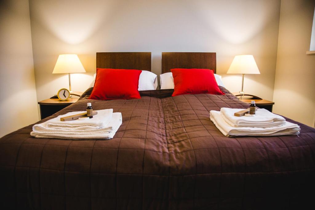 a bedroom with a bed with towels on it at ULMA apartment in Wieliczka