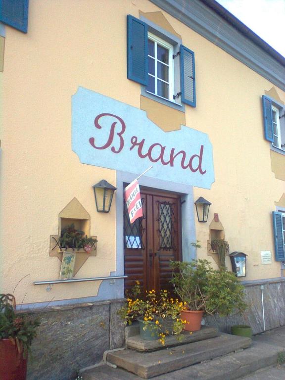 a front of a building with a sign that reads branch at Gasthof Weingut Brand Walter in Hörbing