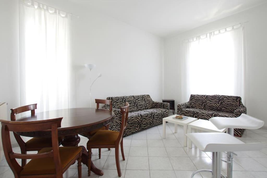 a living room with a table and a couch at Roma Ostia 100 mt sea in Lido di Ostia