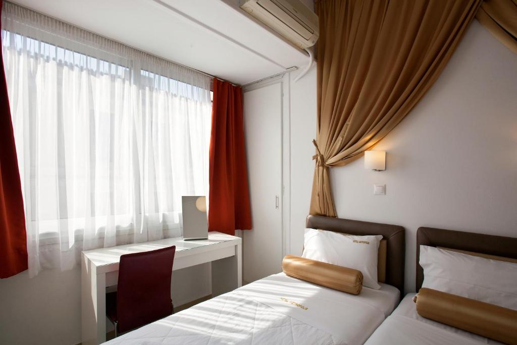 Postel nebo postele na pokoji v ubytování Metropolis Hotel
