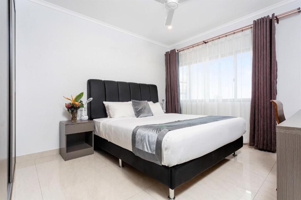 Ένα ή περισσότερα κρεβάτια σε δωμάτιο στο Darwin City Hotel