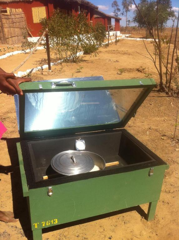 a green stove with a silver pan in it at Ecolodge d'Isalo in Ranohira