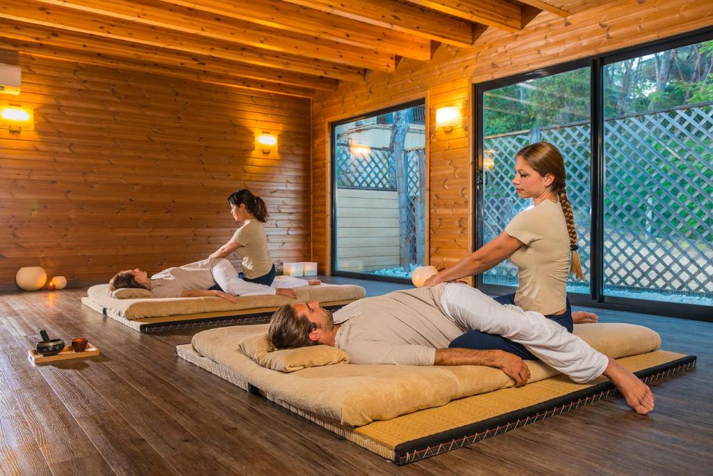 a group of people in a room practicing yoga at Hotel Santa Marta in Lloret de Mar