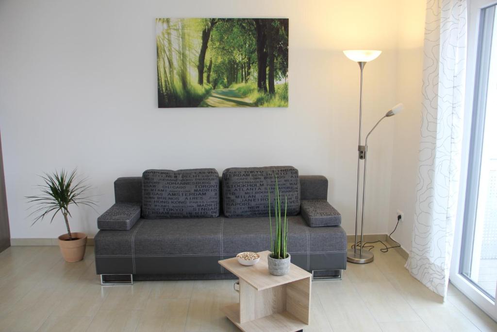 a living room with a couch and a table at Boardinghouse Frank in Langenbach