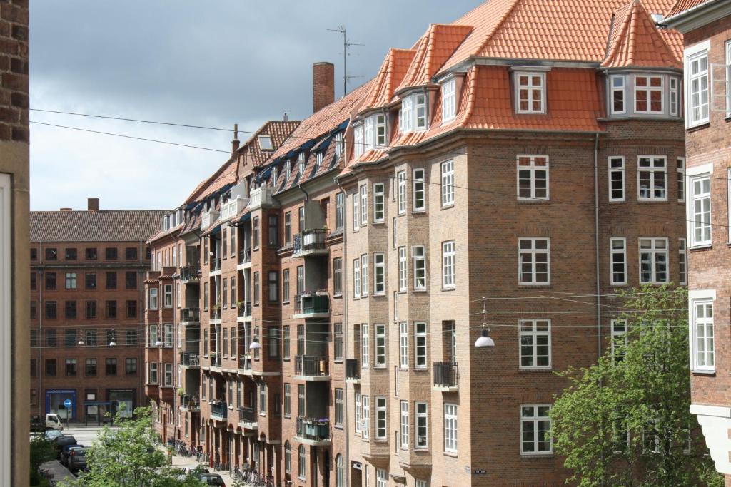 a row of brick buildings in a city at Guesthouse Copenhagen in Copenhagen