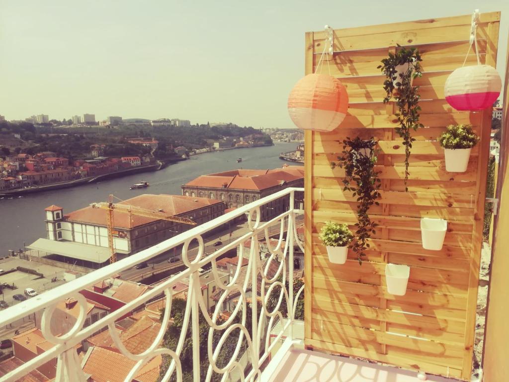 a balcony with potted plants and a view of a river at Oportobestview - TopLoft in Porto