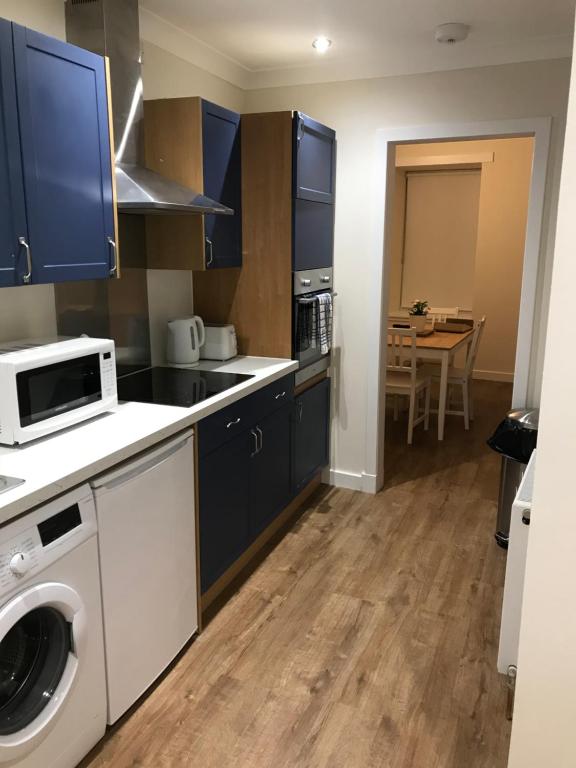 a kitchen with a washer and dryer in it at 2 Lower Kessock Street in Inverness