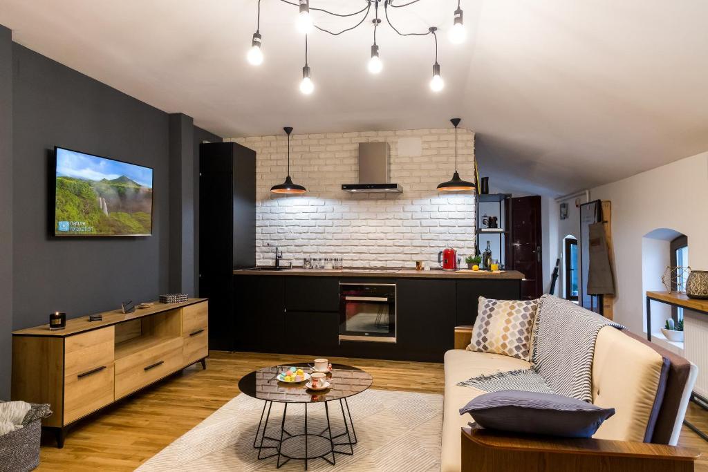 a living room with a couch and a table at Squirrel Apartment in Bucharest