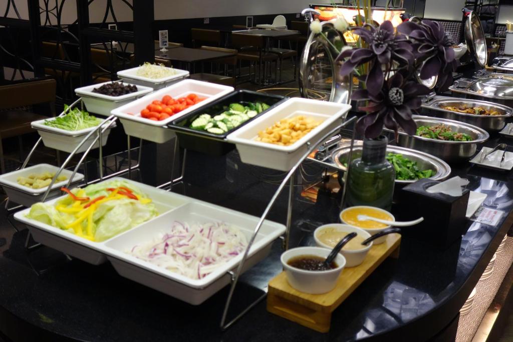 a buffet line with different types of food on a table at The Cloud Hotel in Kaohsiung