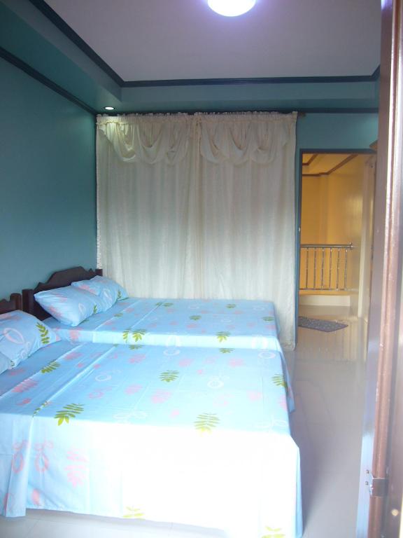 Postel nebo postele na pokoji v ubytování Mary Chiang Baguio Transient House