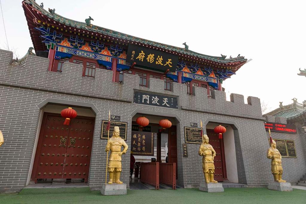 a building with three statues in front of it at Henan Kaifeng·Gulou Square· Locals Apartment 00138460 in Kaifeng