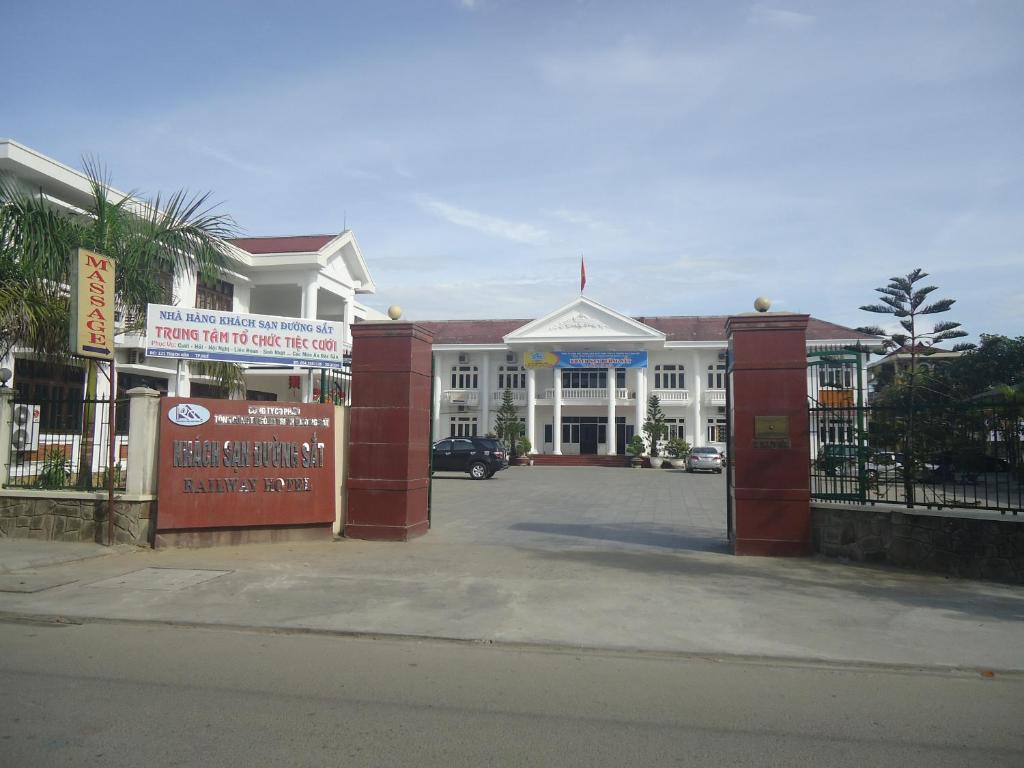 a large white building with a gate in front of it at Hue Railway Hotel in Hue