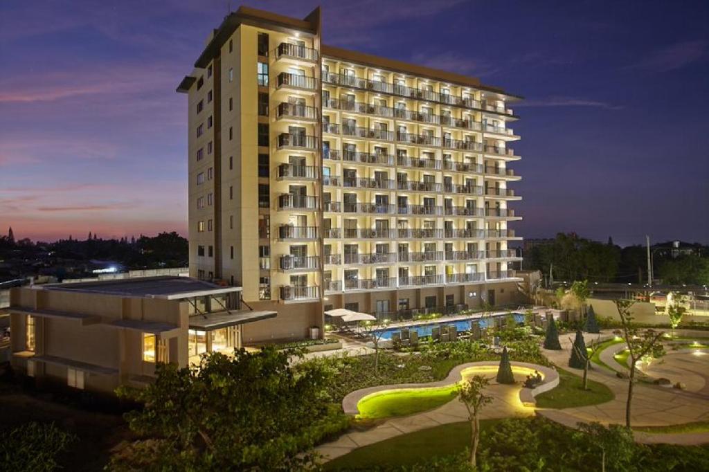 a large building with a lit up building at Quest Hotel Tagaytay in Tagaytay