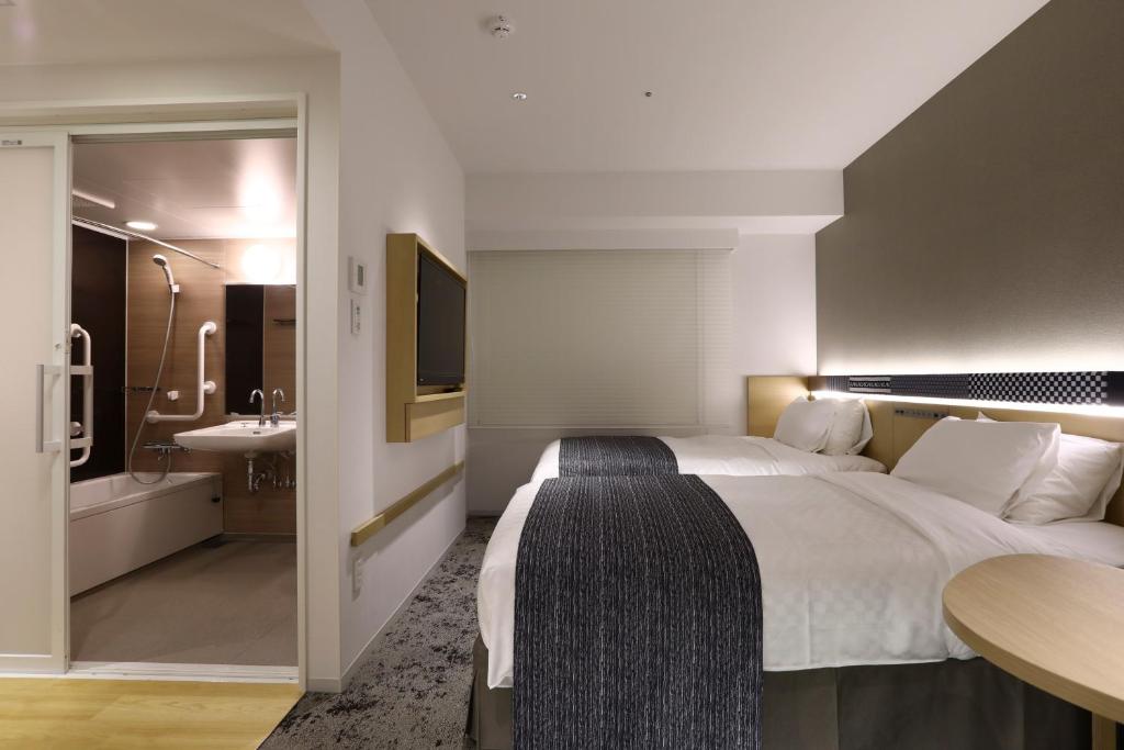 Postel nebo postele na pokoji v ubytování Hotel Gracery Asakusa