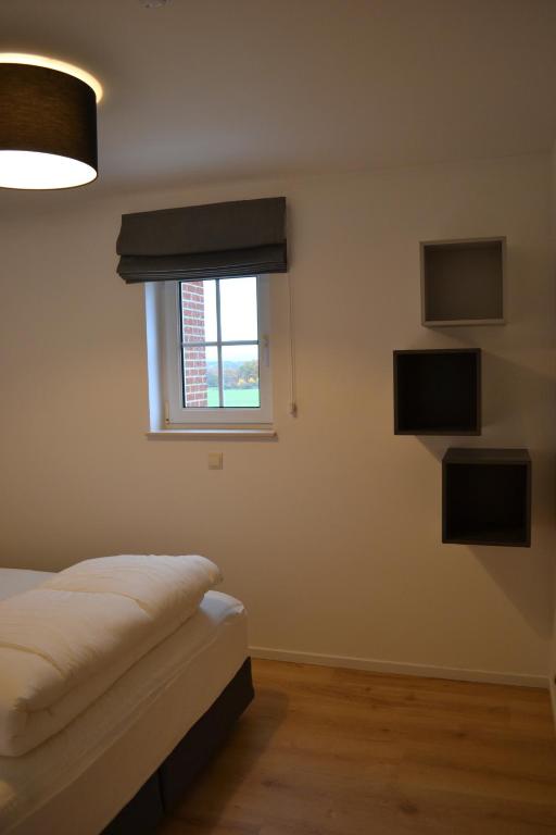 a bedroom with a bed and a window at Vue d'en Haut in Durbuy