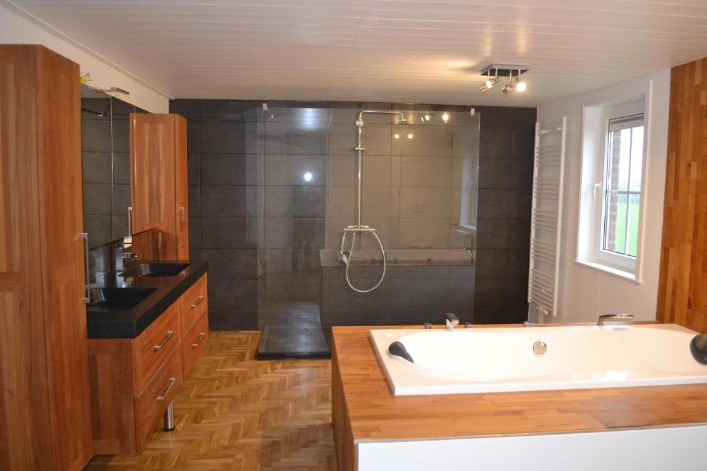 a large bathroom with a tub and a shower at Vue d'en Haut in Durbuy
