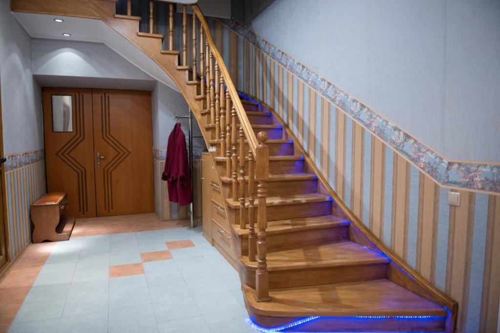 a wooden staircase in a hallway with a door at Don-Antonio in Krasnodar