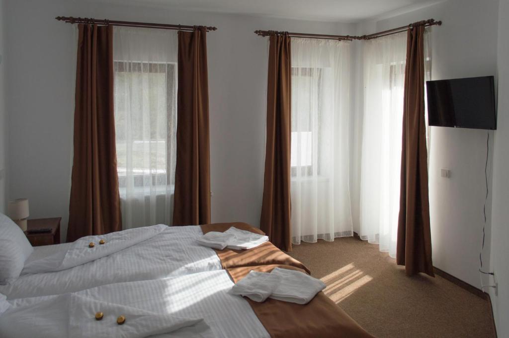 a hotel room with a bed with towels on it at Pensiune Casa Ampeia in Alba Iulia