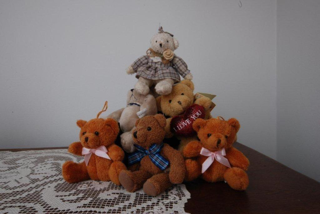 a pile of stuffed teddy bears sitting on a table at B&B 't Walleke in Bruges