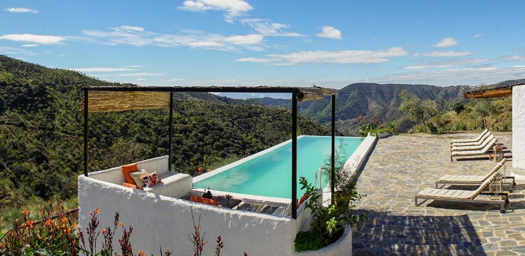 a swimming pool with a view of the mountains at Cortijo Juan Salvador in Olías