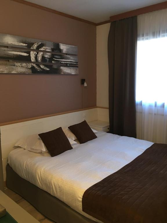 Postel nebo postele na pokoji v ubytování Hôtel Le Rapp