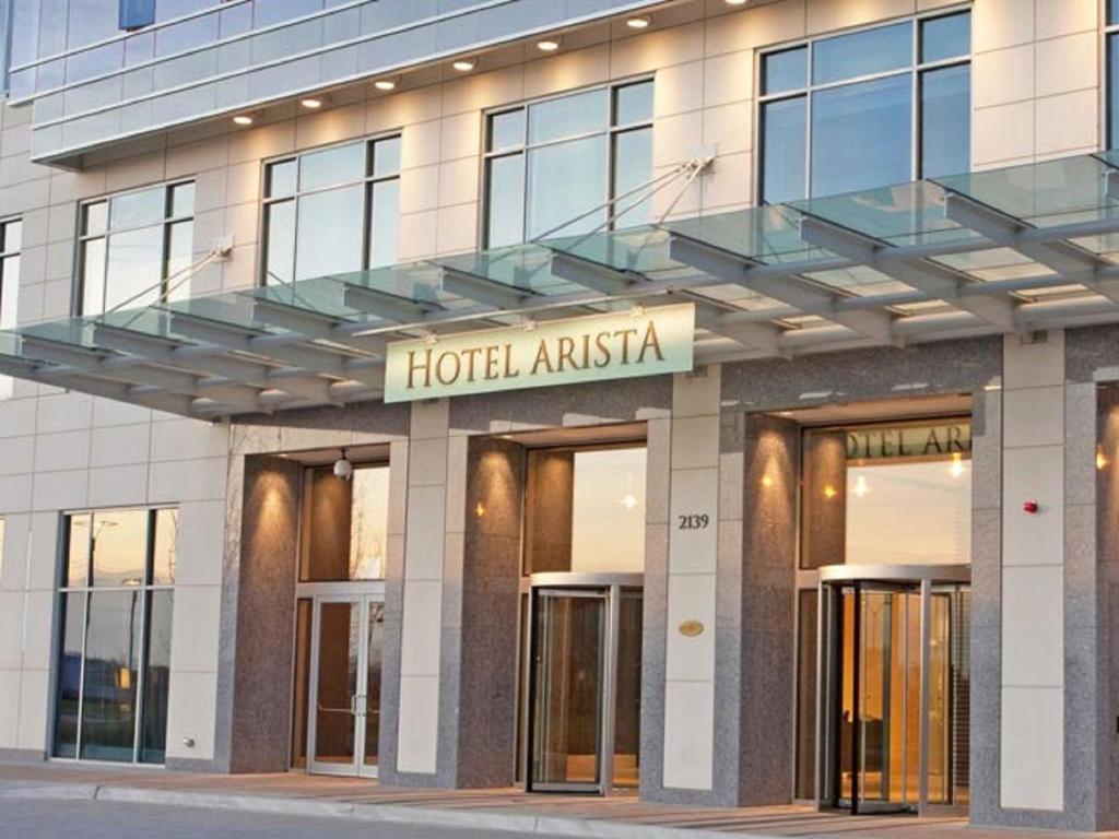 a hotel with a sign on the front of a building at Hotel Arista in Naperville