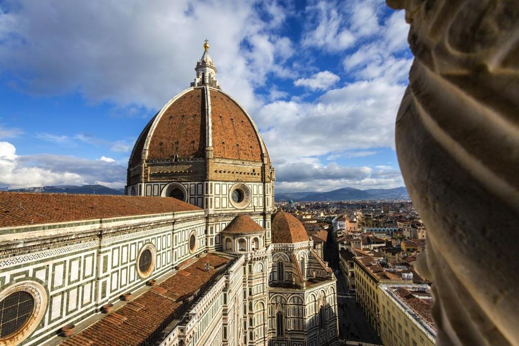 un edificio con una cupola in cima a una città di La Musa di via Dante a Firenze