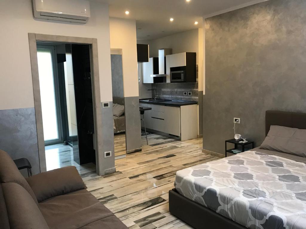 salon z łóżkiem i kuchnią w obiekcie B&B ATTICO GALLIERA w Bolonii