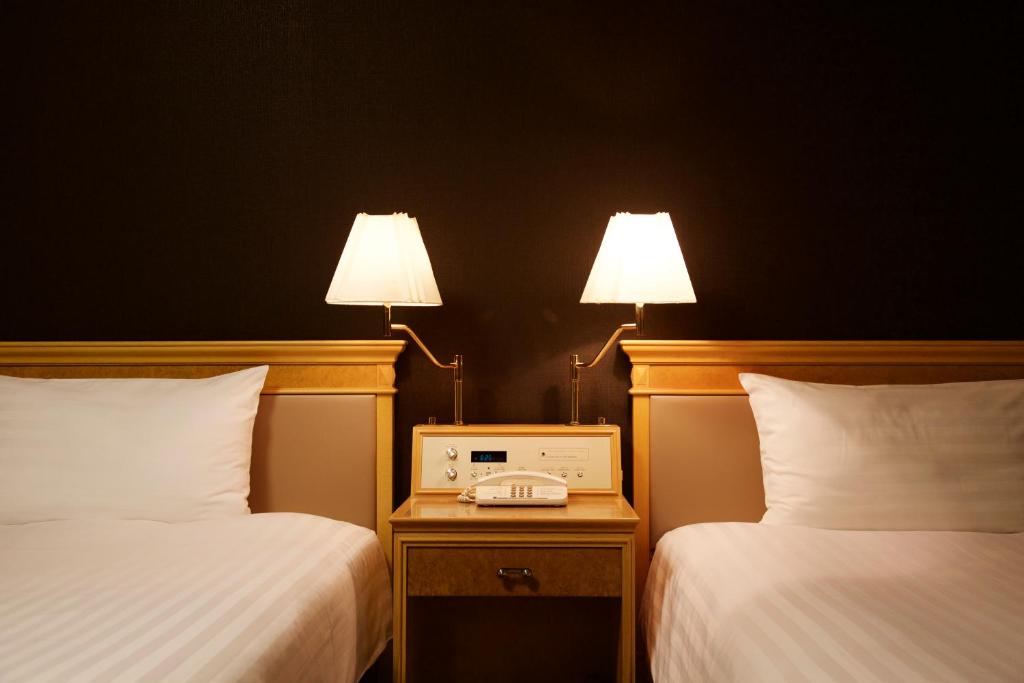 Postel nebo postele na pokoji v ubytování Hotel Agora Regency Osaka Sakai