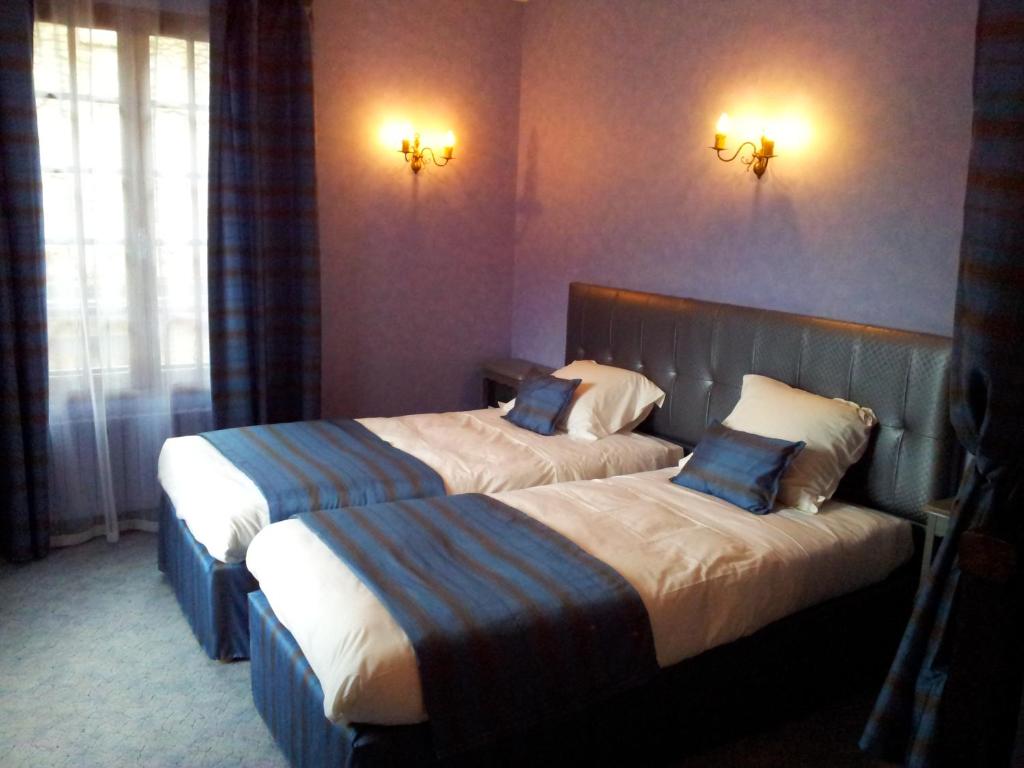 Postel nebo postele na pokoji v ubytování Hôtel Sainte Foy