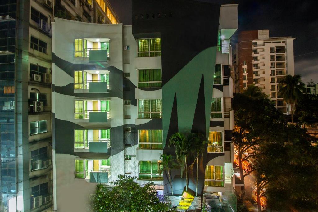 a tall building with many windows at night at Rafflesia Serviced Apartments in Dhaka