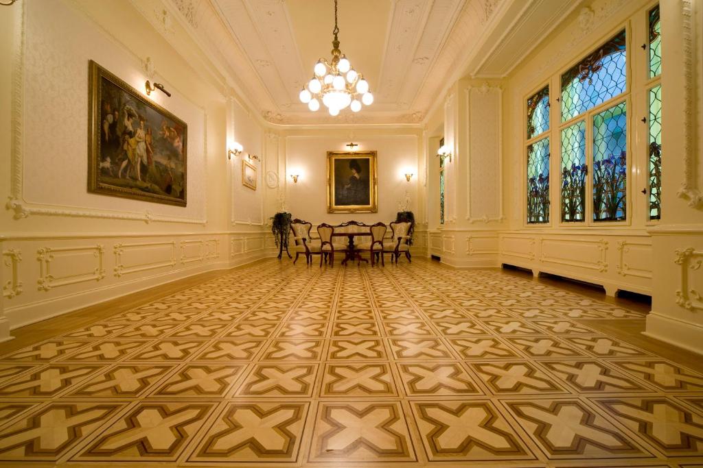 an empty room with a table and chairs in it at Boutique Hotel Victoria Budapest in Budapest