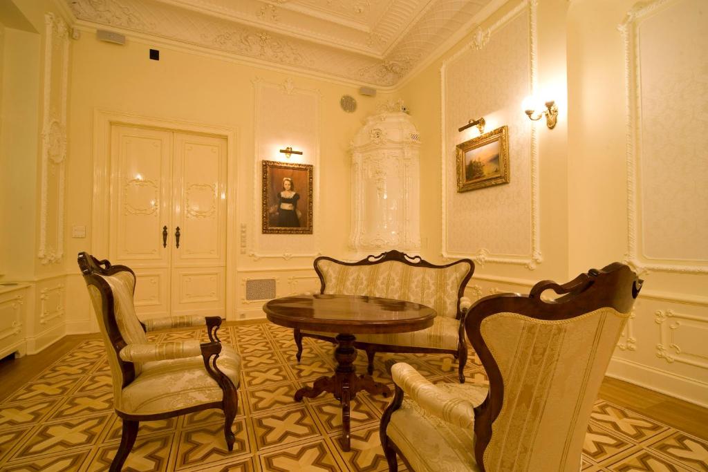 a room with a table and chairs in a room at Boutique Hotel Victoria Budapest in Budapest
