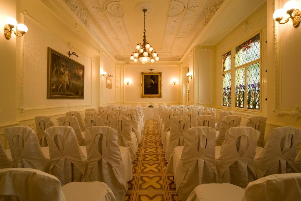a room with a bunch of chairs in it at Boutique Hotel Victoria Budapest in Budapest