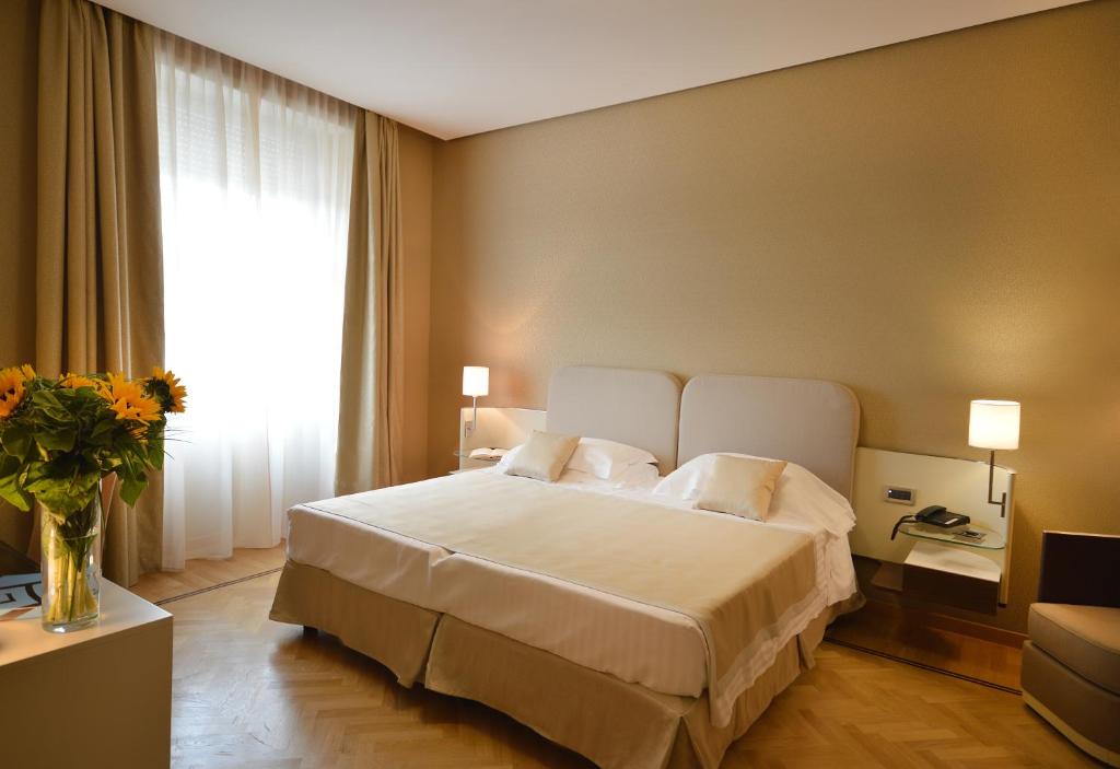 Postel nebo postele na pokoji v ubytování Palazzo Esedra